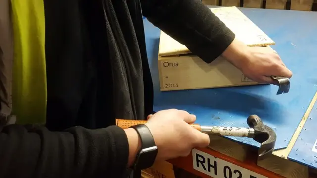 Мулен и его помощники открывают деревянные ящики, чтобы проверить каждую бутылку