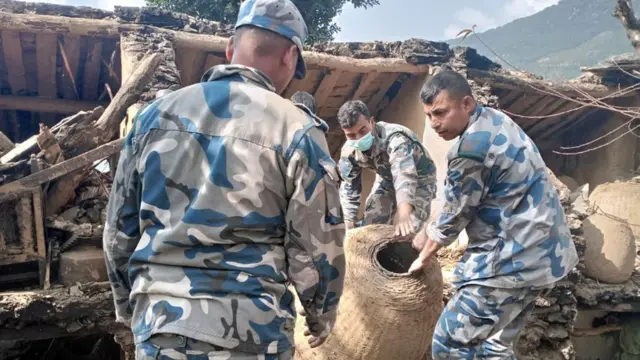 भूकम्पले क्षति पुगेको घरबाट सामान निकाल्दै सशस्त्र प्रहरी