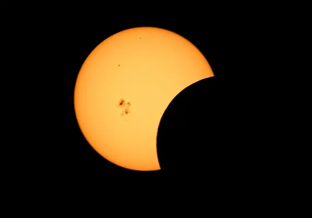 Partial solar eclipse with large sunspot as seen from southern New Mexico