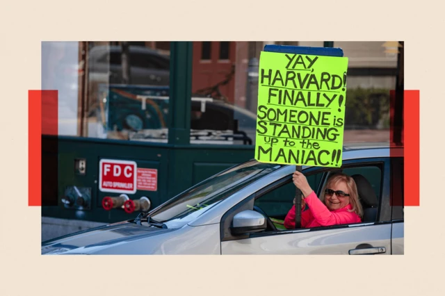 A demonstrator holds a sign in Harvard Square after a rally was held against Donald Trump's attacks on Harvard University on 17 April 2025.