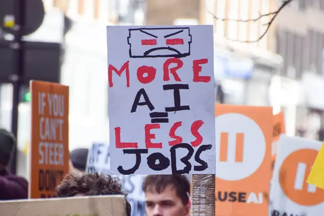 A protester holds an anti-AI placard outside OpenAI offices
LONDON, UNITED KINGDOM - 2026/02/28: A protester holds an anti-AI placard outside OpenAI offices in King's Cross during a march against unregulated Artificial Intelligence (AI) and data centres. (Photo by Vuk Valcic/SOPA Images/LightRocket via Getty Images)