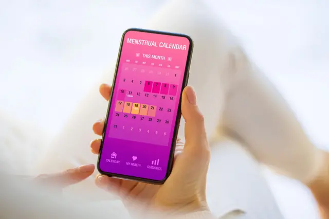Phone screen with period tracking calendar