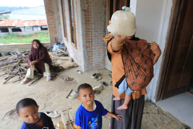 Warga korban terdampak bencana hidrometeorologi memperlihatkan bantuan beras di Desa Kayu Kul, Kecamatan Pegasing, Aceh Tengah, Aceh, Jumat (12/12/2025). Menurut keterangan warga terdampak bencana hidrometeorologi, bantuan yang masuk ke Aceh Tengah masih terbatas dan memasuki minggu ketiga pascabencana mereka baru mendapatkan bantuan beras sebanyak 2,5 kilogram per kepala keluarga.