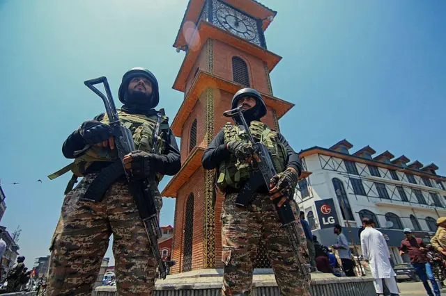 Indian soldiers stand alert near the clock tower in Srinagar, India-administered Jammu and Kashmir, during a Tiranga rally on May 22, 2025 to celebrate the "Operation Sindoor" in which Indian forces conducted missile strikes in Pakistan in the wake of the Pahalgam attack in which 26 civilians were killed on 22 April 2025. (Photo by Faisal Khan / Middle East Images / Middle East Images via AFP) (Photo by FAISAL KHAN/Middle East Images/AFP via Getty Images)