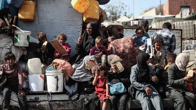 Famílias com crianças amontoadas em um caminhão com poucos pertences estão tentando fugir da Cidade de Gaza.