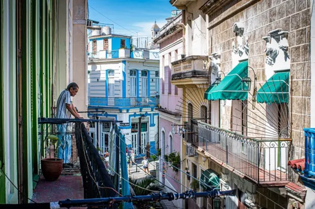 A man watches over his balcony