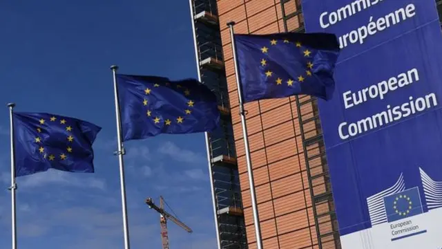 European Union flags next to the European Commission headquarters in Brussels