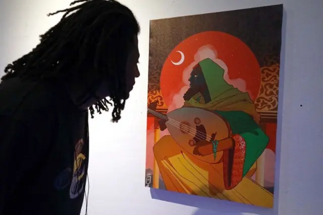 On Sunday a visitor takes in one of the pieces at Libya's Tra Tani exhibition, described as a puzzle game consisting of artworks by local artist