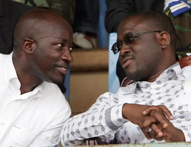 Charles Blé Goudé and Guillaume Soro sit and talk at an event in 2007.