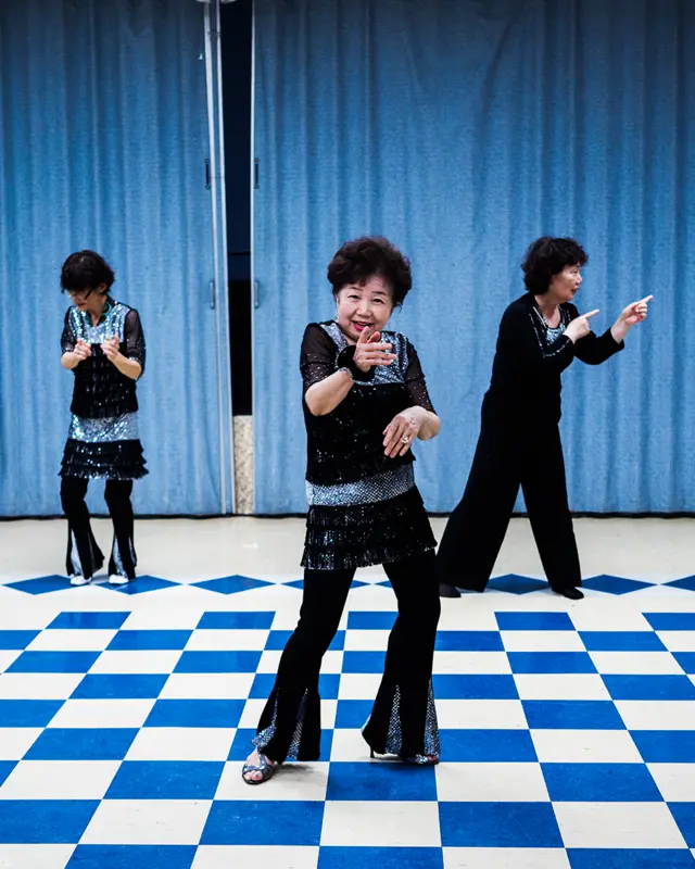 Three women dance and pose for the camera
