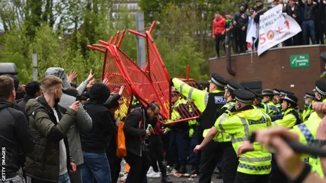Manchester United fans protest outside Old Trafford against the club's ownership under the Glazer family