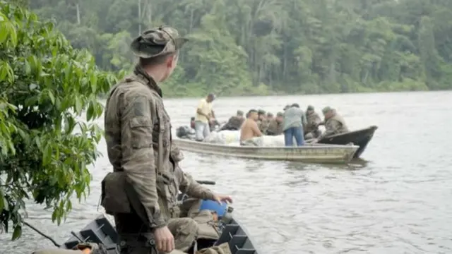 Militar observa homens sendo revistadosesporte da sorte ufcbarco no meio da floresta