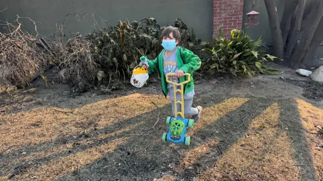 Um menino brinca com um cortadoraposta artilheiro copagramaaposta artilheiro copabrinquedo usando uma máscara