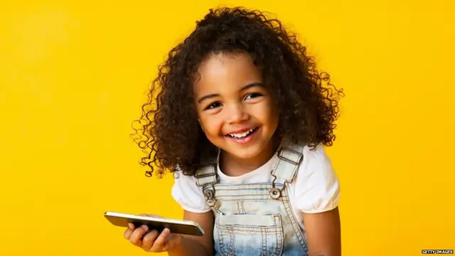 Young black girl holidng a mobile phone