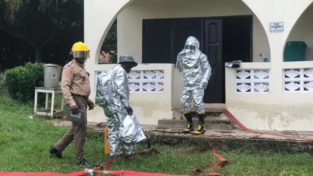 fire crew fighting bees in a building 