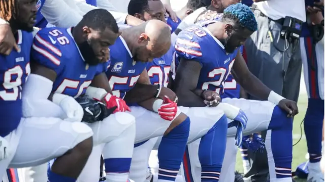 Buffalo Bills players kneel during the American National anthem before an NFL game against the Denver Broncos, 24 September 2017