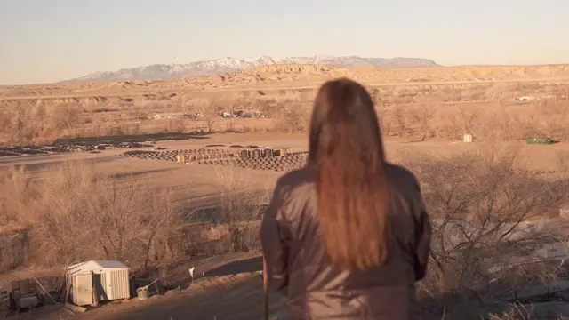 Bea Redfeather looks out at the top of a hill near her property in Shiprock, New Mexico