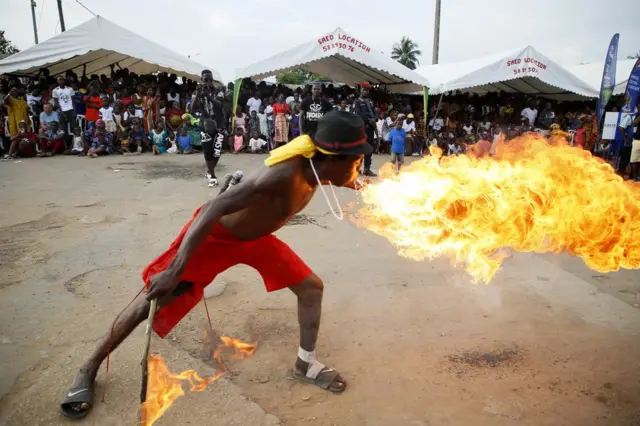 A man breathes fire as part of the parade, on the last day of the Popo Carnival in Bonoua, south of Abidjan.