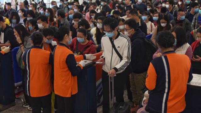 People with masks queuing at Hong Kong's airport