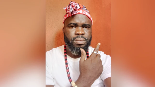 Chekwube Okwunwendu wear white T-shirt and neck and wrist beads wit traditional cap.