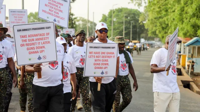 some officials from di small arms commission with placards during one of dia'gun amnesty' march for communities