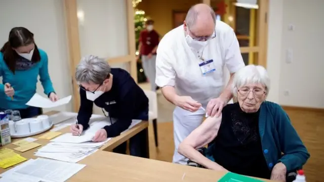 An elderly woman receives the Pfizer-BioNTech coronavirus disease (COVID-19) vaccine at a nursing home in Burgbernheim, Germany, December 28, 2020