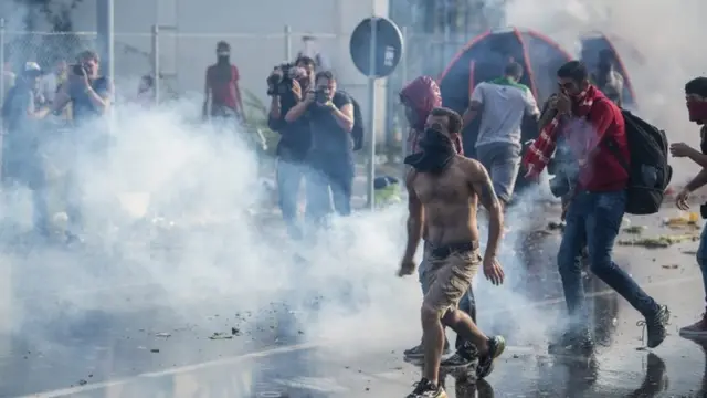 Hungarian police use tear gas at the border crossing into Hungary, near Horgos, Serbia, Wednesday, Sept. 16, 2015