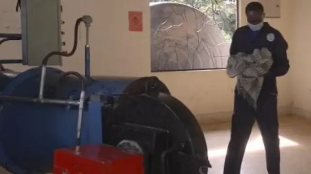 Mchoma maiti akipeleka mzoga kwenye mashine ili shughuli ya uchomaji ianze rasmi. Ni shughuli ambayo huchukua saa mbili kabla ya mmiliki wa mnyama kupatiwa jivu la mnyama wake.