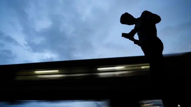 A man walks with his mobile phone on November 2, 2023, in Colombo, Sri Lanka. 