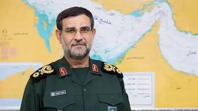 Alireza Tangsiri wear im force uniform wey be deep green, e wear glasses as e look in side camera wit strong face.