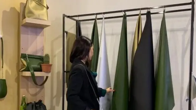 A woman looks at the cactus leather sheets