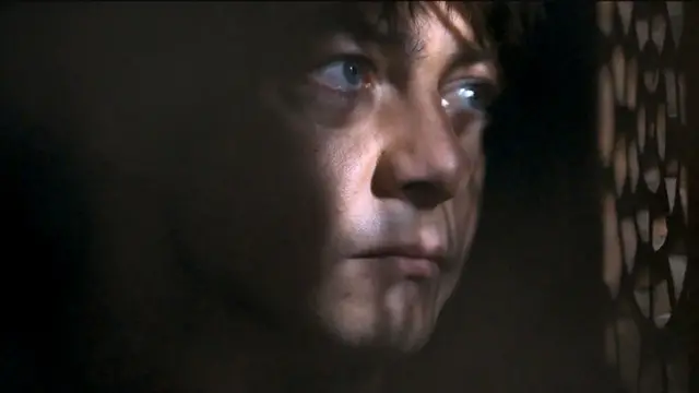 Man wey dey dark room dey look out