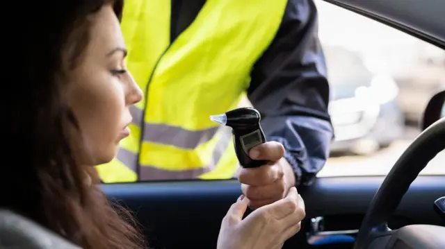 A young woman preparing to do a breathalyser text