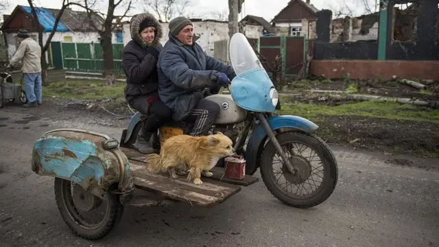 Пара на мотоциклі і пес