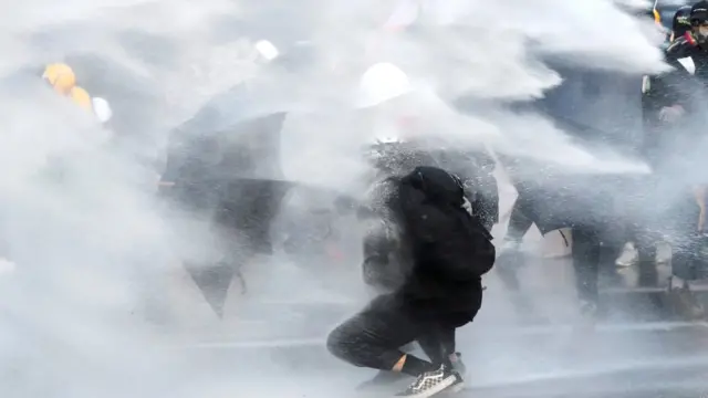 protester amid water cannon