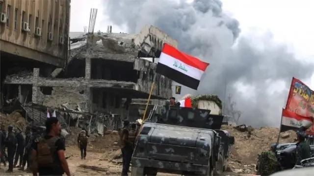 Members of the Iraqi federal police vehicles are seen in the Old City of Mosul on 8 July