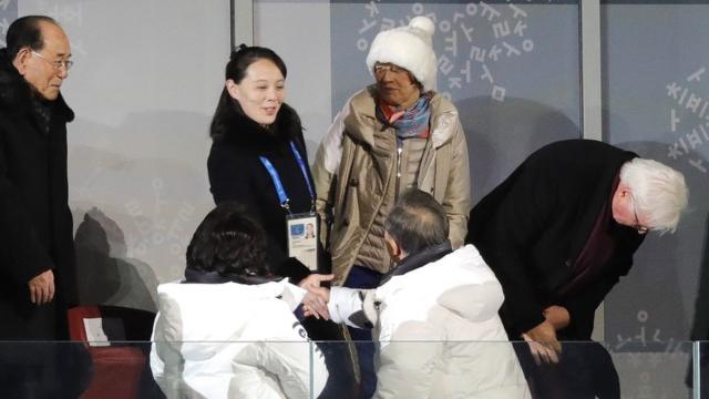 Ms Kim (C) shook hands with Mr Moon at the opening ceremony
