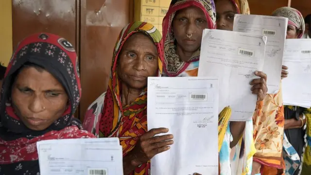 Women wait in queue to verify their names on National Register of Citizens draft in Assam on 30 July 2018.
