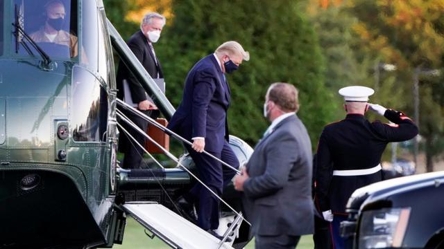 President Donald Trump disembarks from the Marine One helicopter as he arrives at Walter Reed National Military Medical Center