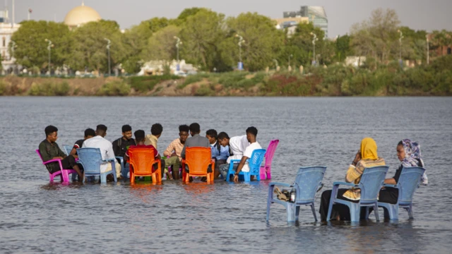 People sitting on chairs in the River Nile in Khartoum, Sudan - Tuesday 25 May 2021
