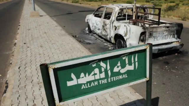 Burnt military vehicle wey dey for lonely road for Yobe.