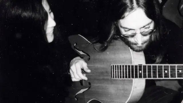 John Lennon playing the guitar