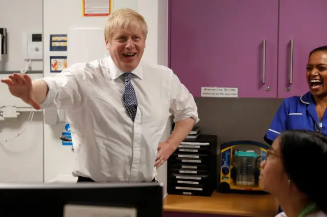 British Prime Minister Boris Johnson greets and speaks to nurses at National Institute for Health Research at the Cambridge Clinical Research Facility