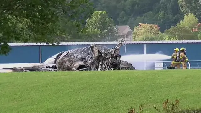 Firefighters tackle flames engulfing an aircraft that crashed in Tennessee