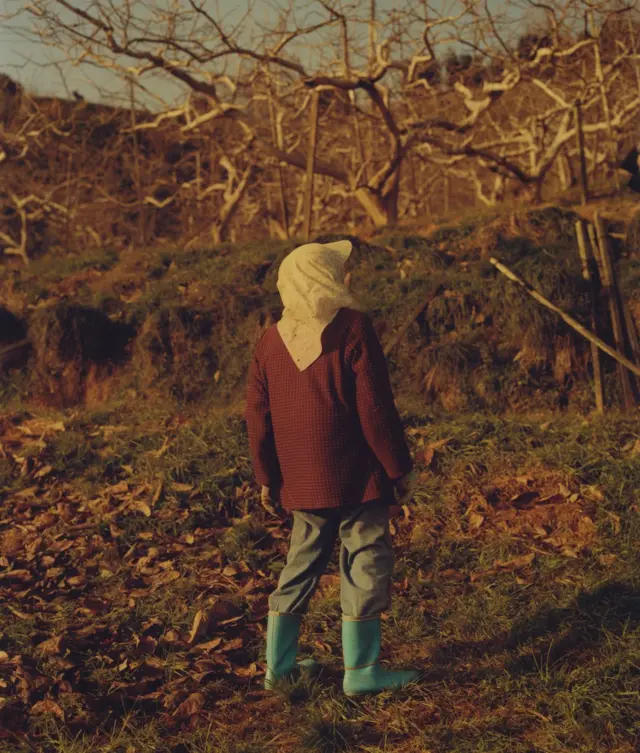 A man stands with his back to the camera