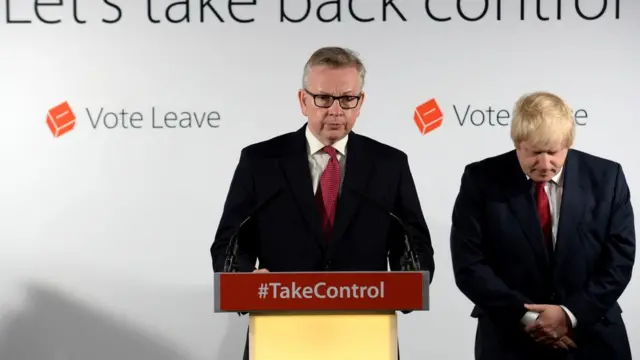 Michael Gove (no pódio) e Boris Johnson