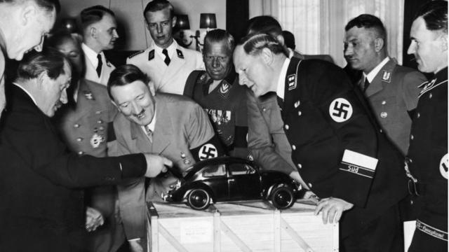 Adolf Hitler inspects a VW model car