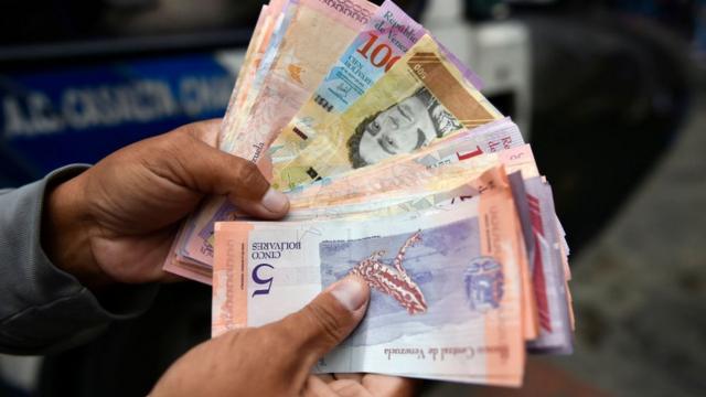 Una mano con billetes en Venezuela.
