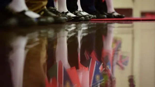 Chinese children wait for the arrival of Namibia's President Hage Geingob and China's President Xi Jinping during a welcome ceremony at the Great Hall of the People in Beijing on March 29, 2018. Hage Geingob is on a visit to China from March 28 to April 3.