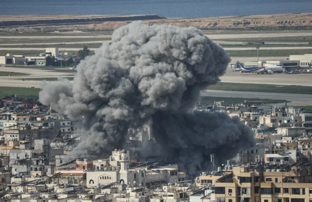 Smoke rises from the site of an Israeli airstrike that targeted the Al Lailaki neighbourhood in Beirut's southern suburbs, with the city's international airport visible in the background, on March 4, 2026.